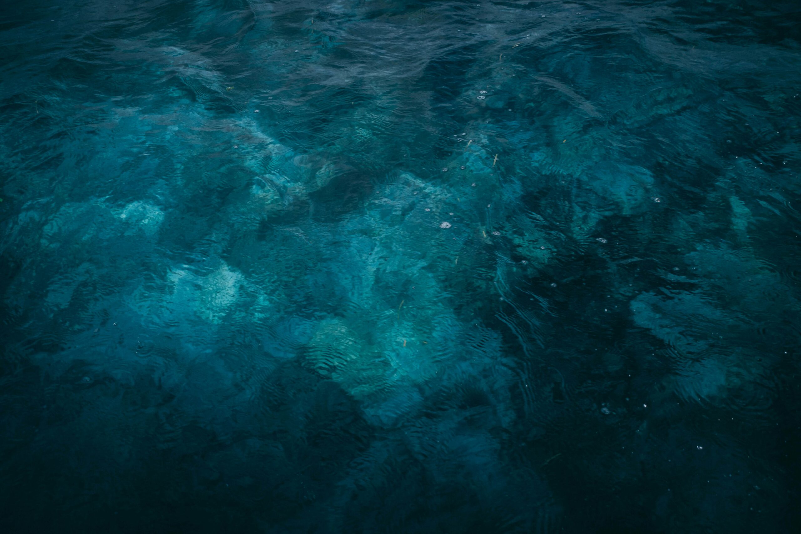 Dark teal water surface, background image for an article on low testosterone symptoms in men